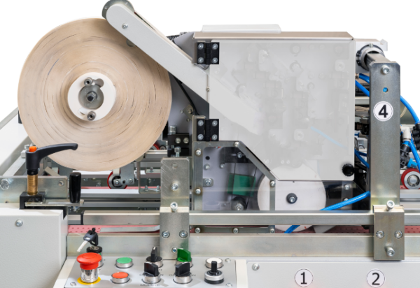 Macari-Fidia Estream contactless double-sided tape applicator with its tape reel